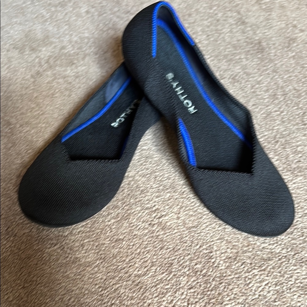 Rothy's WASHABLE Black Flats with Vibrant Blue Accent.